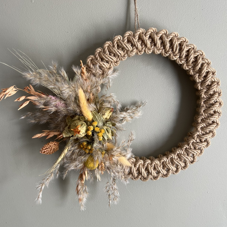 An image of a woven wreath with dried flowers to advertise a Macramé Spring Wreath & Brunch Workshop event at The Cart & Horses.