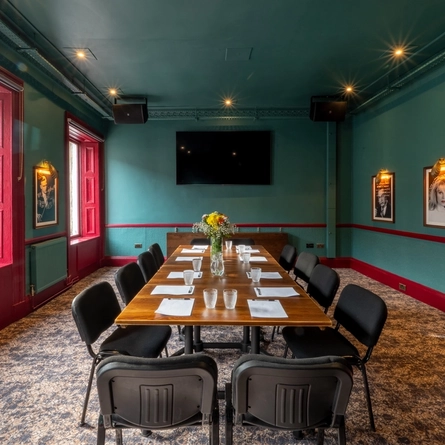 A large function/meeting room at The Beehive Inn, with a boardroom table, and a TV on the wall.