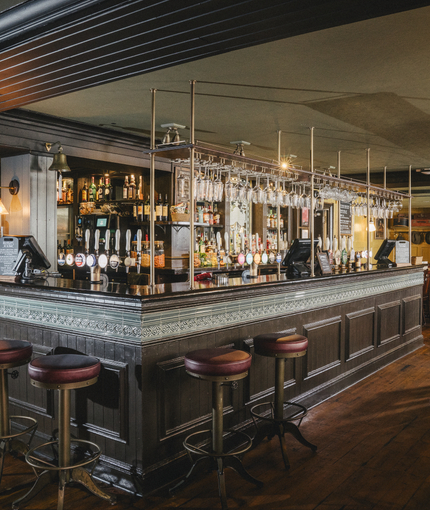 The interior bar and restaurant seating area at the Three Tuns.