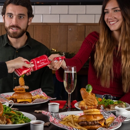 a group of people eating at a table of a pub