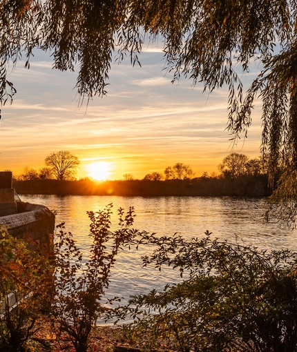 An exterior sunset waterside view from The Crabtree.