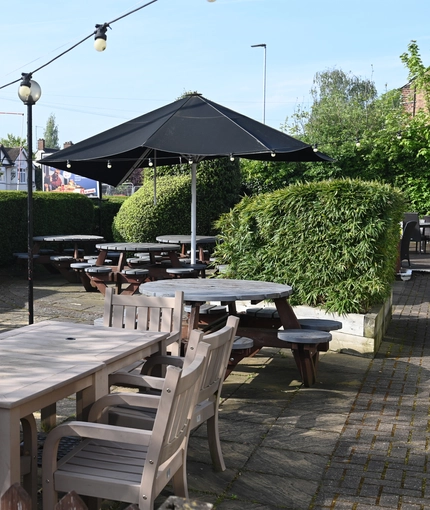 Exterior beer garden of a pub with a seating area.