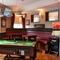 interior dining area of a pub with a pool table and a TV