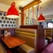 Interior dining area of a pub with a TV.