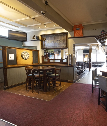 Interior shot featuring the bar, seating area and dart board