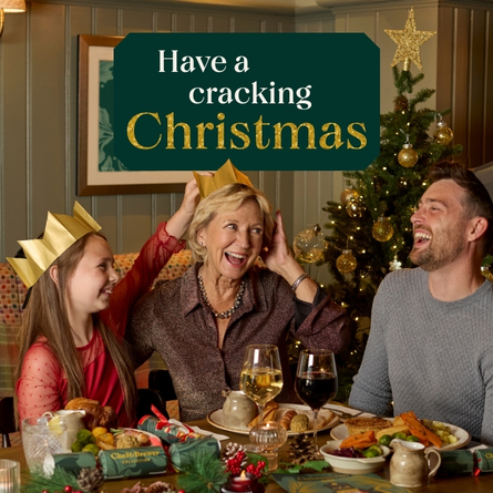 A banner showing a family sat at a table enjoying drinks and food with the wording "Have A Cracking Christmas" to advertise the Festive period at Chef & Brewer venues.