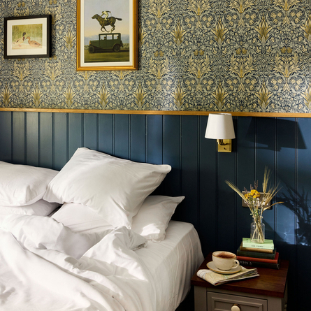 Hotel bedroom with artwork and decorated bedside table