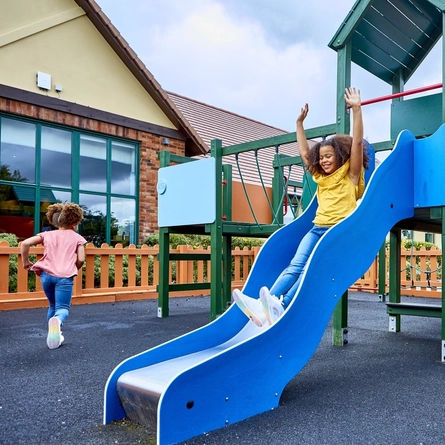 A child going down the slide in our outdoor play area