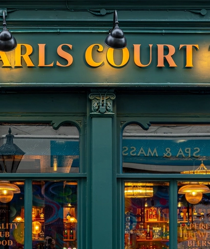 A closed up view of the exterior facade and signage of The Earls Court Tavern.