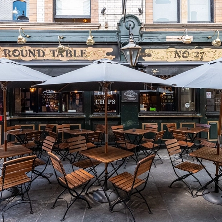 Outdoor seating area with umbrellas for shade outside the Round Table