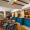 The bar and interior restaurant seating area at The Walkford, with wooden beams on the ceiling.