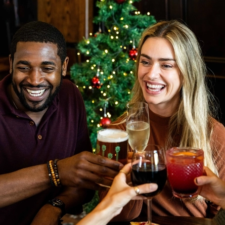 Two people celebrating Christmas in a pub