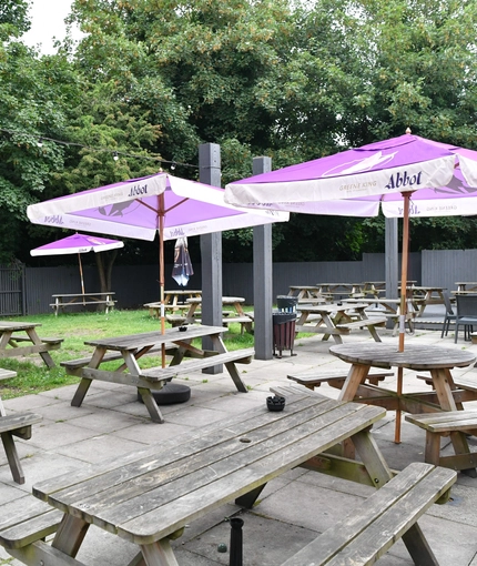 exterior beer garden of a pub with a seating area and a play area