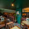 An interior restaurant seating area at The Junction in Upminster, with TVs on the walls.