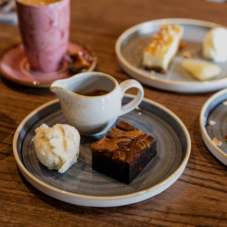 a plate of food sitting on a wooden table of a pub