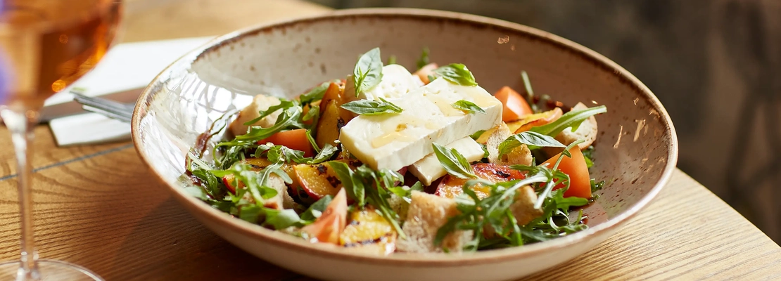 An advertising image of a Halloumi Vegetable Grain Salad bowled dish available at Chef & Brewer venues this Summer.