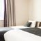 The interior of one of the hotels room featuring a double and a single bed at The Quays.