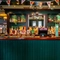 A close up view of the bar and beer taps at the Royal George in Euston; with golden drinks trays on the counter, and bottles of alcoholic spirits on illuminated wooden shelves behind the bar.