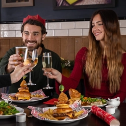 a group of people eating at a table of a pub