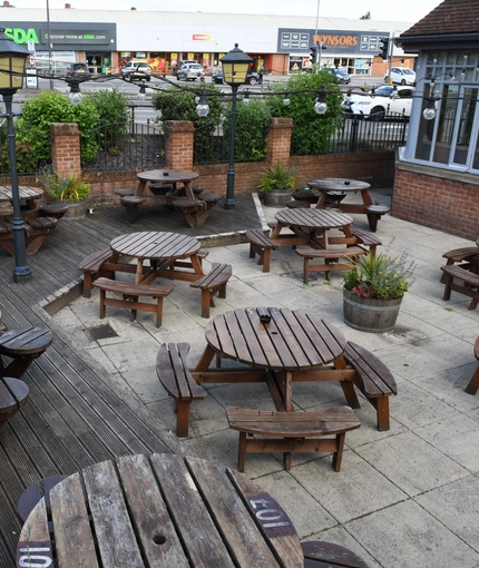 Exterior beer garden of a pub with a seating area.