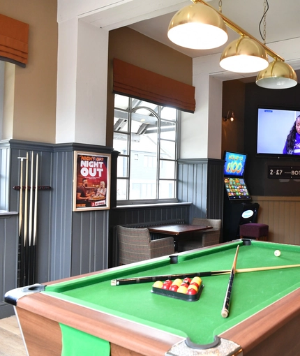 interior seating area and pool table of the pub