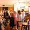 An image of customers stood within the interior restaurant seating area with the bar in the background enjoying drinks at The Kings Stores.