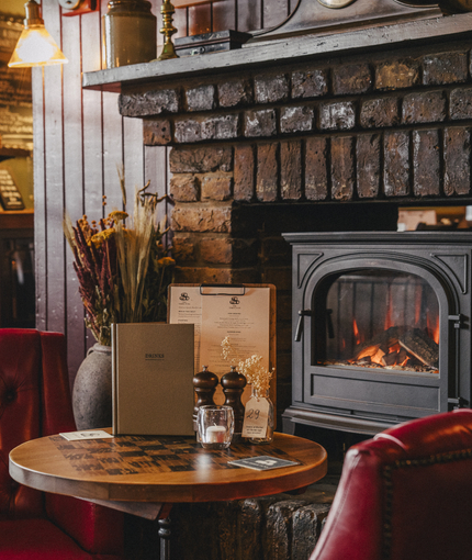 The interior restaurant and seating area with fireplace at the Three Tuns.