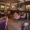 The interior restaurant seating area with feature fireplace at The Crown & Horseshoes.