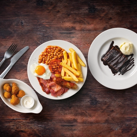 A seniors side of garlic breaded mushrooms and all day breakfast with a dessert of chocolate fudge brownie Served at Flaming Grill venues in 2024.