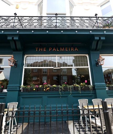 An exterior shot of the facade & signage at The Palmeira in Hove.
