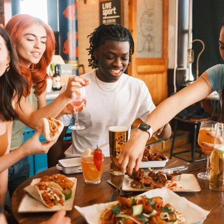 Group eating sharers with drinks