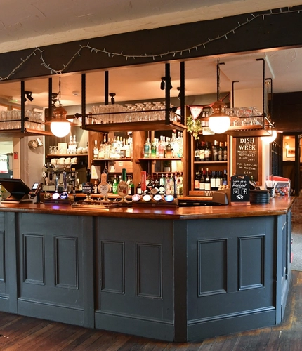 Interior bar area and dining area of a pub.