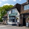 Exterior facade of a pub with a seating area on the side.