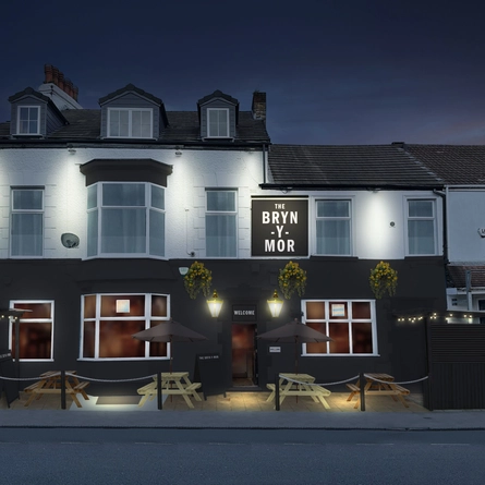 An illustration of the exterior facade with outdoor seating during the evening at The Bryn Y Mor.