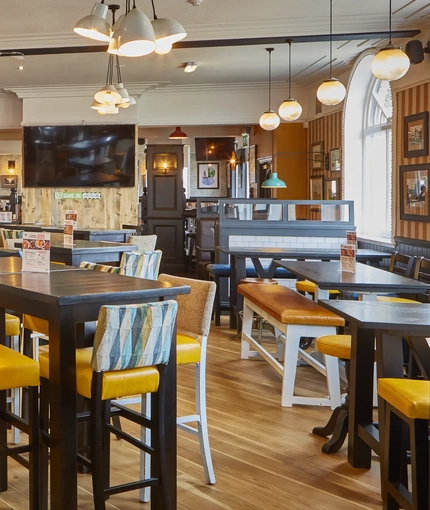 The interior restaurant and seating area with TV at The Fountain.