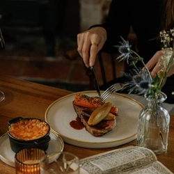 A lifestyle image of a plated main dish from the Burns Night menu sat on a table within the interior restaurant seating area at The Crown.