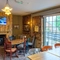 Interior dining area of a pub with a TV and a fireplace.