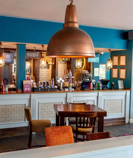 Interior dining area of a pub with a bar.