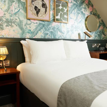 A bed in a hotel room of The Narborough Arms.