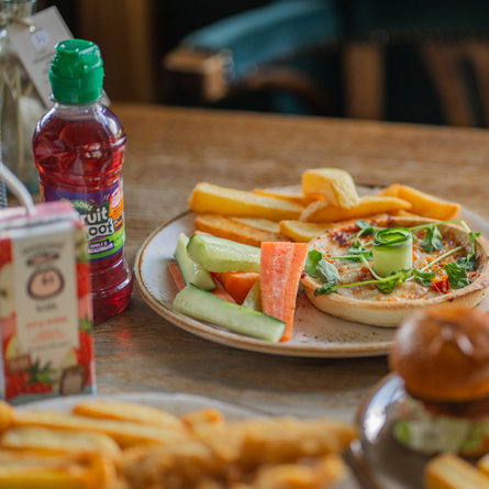 A young guests pizza dish served with chips and veg sticks available at Chef and Brewer venues.