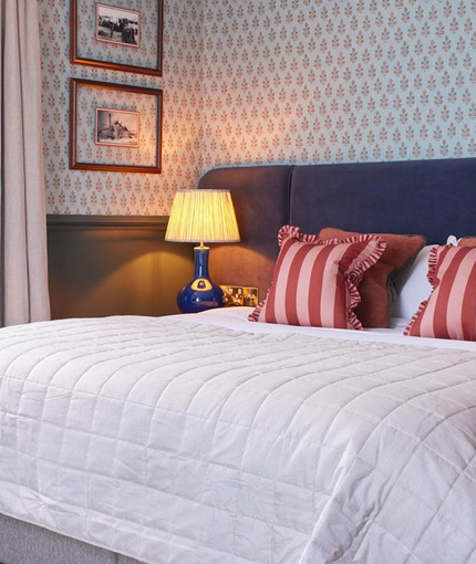 Double bed in hotel room with a sofa bed 