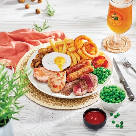 Food presented on a plate sat on a woven place mat with a napkin