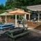 The exterior beer garden seating area with partial covered area and outdoor TV at The Hare & Hounds.