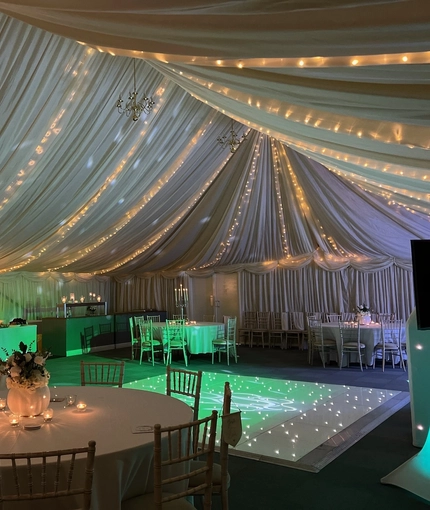A marquee, decorated for a wedding.