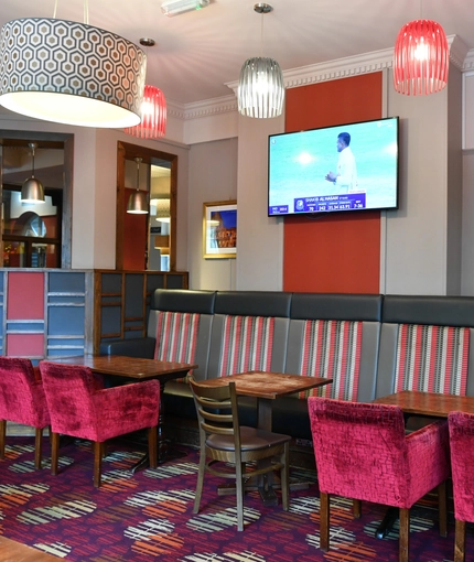 interior dining area of a pub with a TV