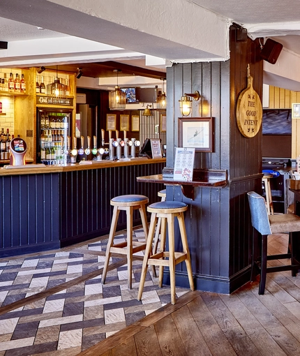 The bar and interior restaurant seating area with pub games, at The Good Intent in Hornchurch.