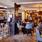 The bar and interior restaurant seating area with pub games, at The Good Intent in Hornchurch.