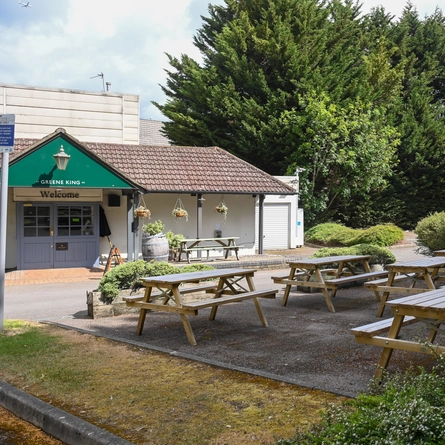 The exterior of the venue with outdoor wooden bench seating at The Willow.