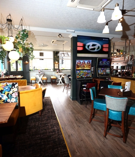 An interior shot of the main seating area, pub games & bar at The Palmeira in Hove.