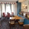 Interior dining area of a pub with a TV.